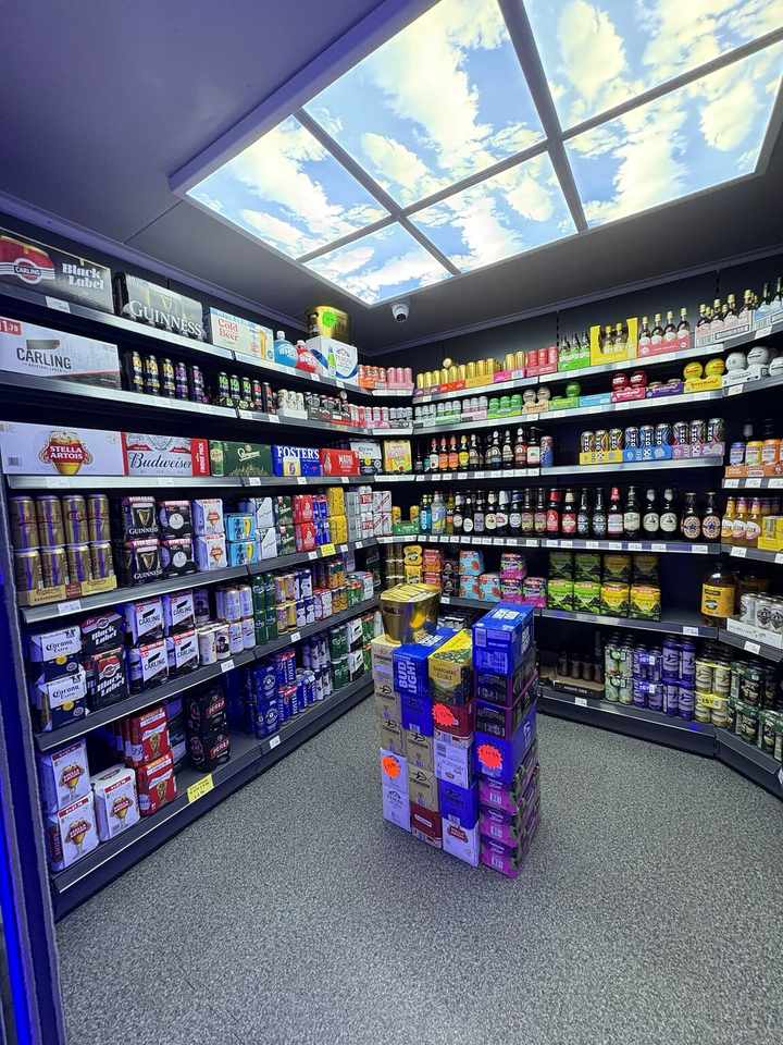 Beer, cider and pre-mixed drinks arranged in the off-licence section at C&K Local Store in Worcester.