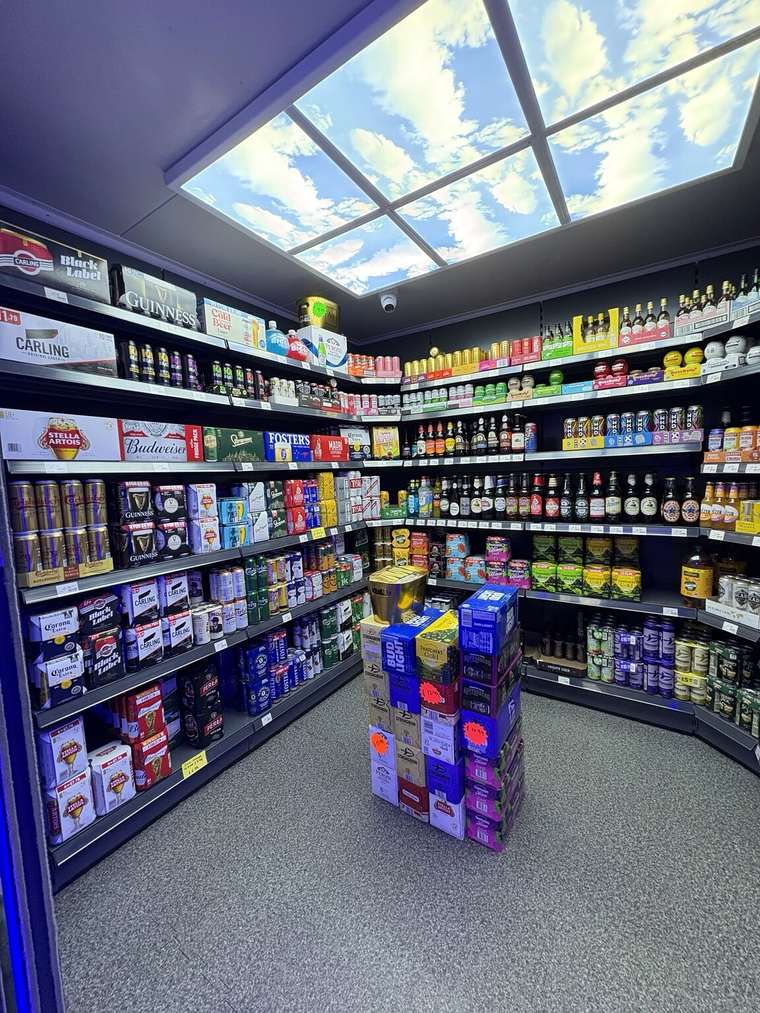 Beer, cider and pre-mixed drinks arranged in the off-licence section at C&K Local Store in Worcester.