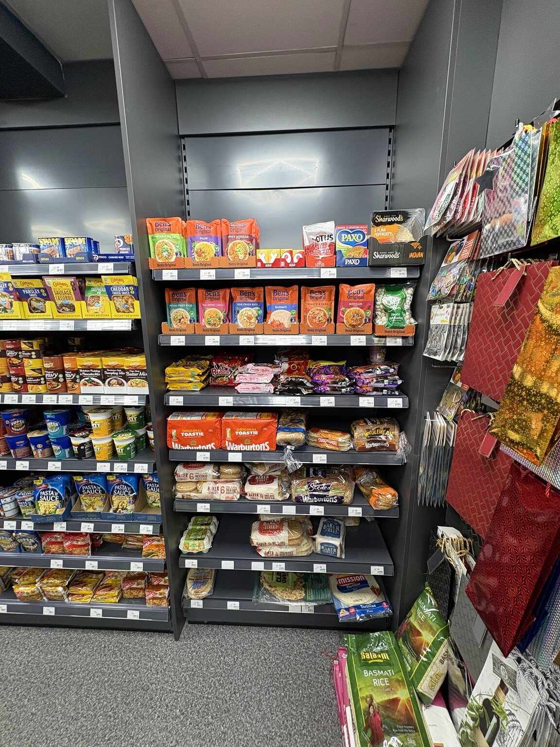 Rice, bread, wraps and meal ingredients displayed inside C&K Local Store on London Road, Worcester.