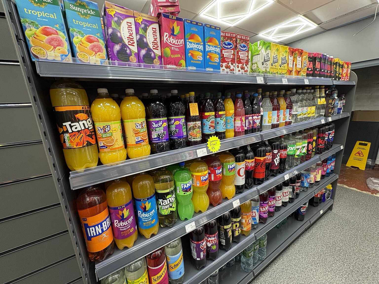 Fruit juice, fizzy drinks and bottled soft drinks displayed at C&K Local Store in Worcester.