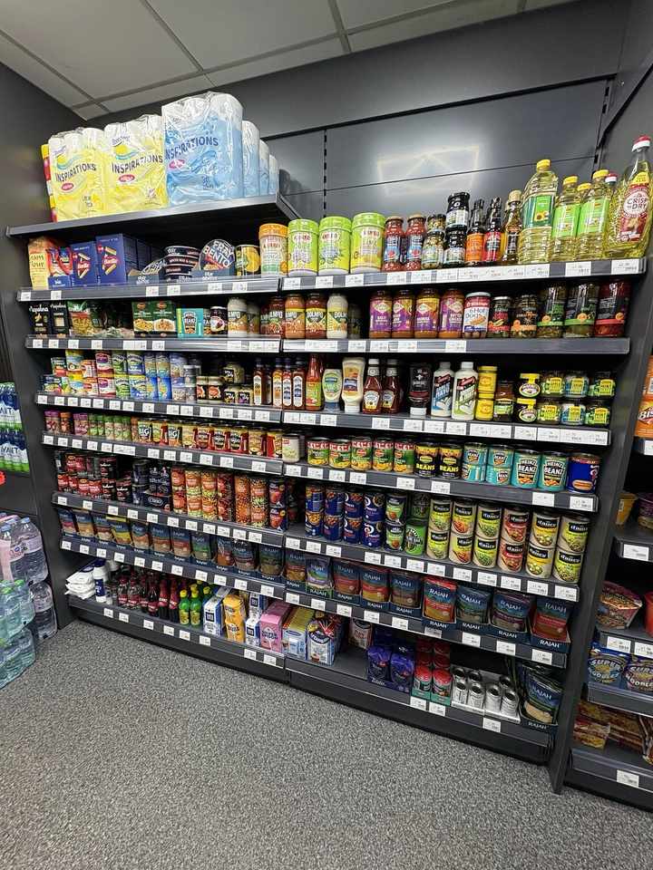 Groceries, cooking sauces, oils, tinned food and spices displayed at C&K Local Store in Worcester.