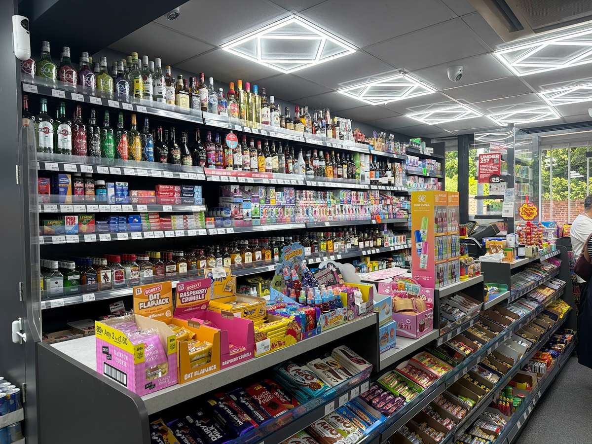 Inside C&K Local Store: well-stocked shelves of spirits, groceries, snacks and confectionery.
