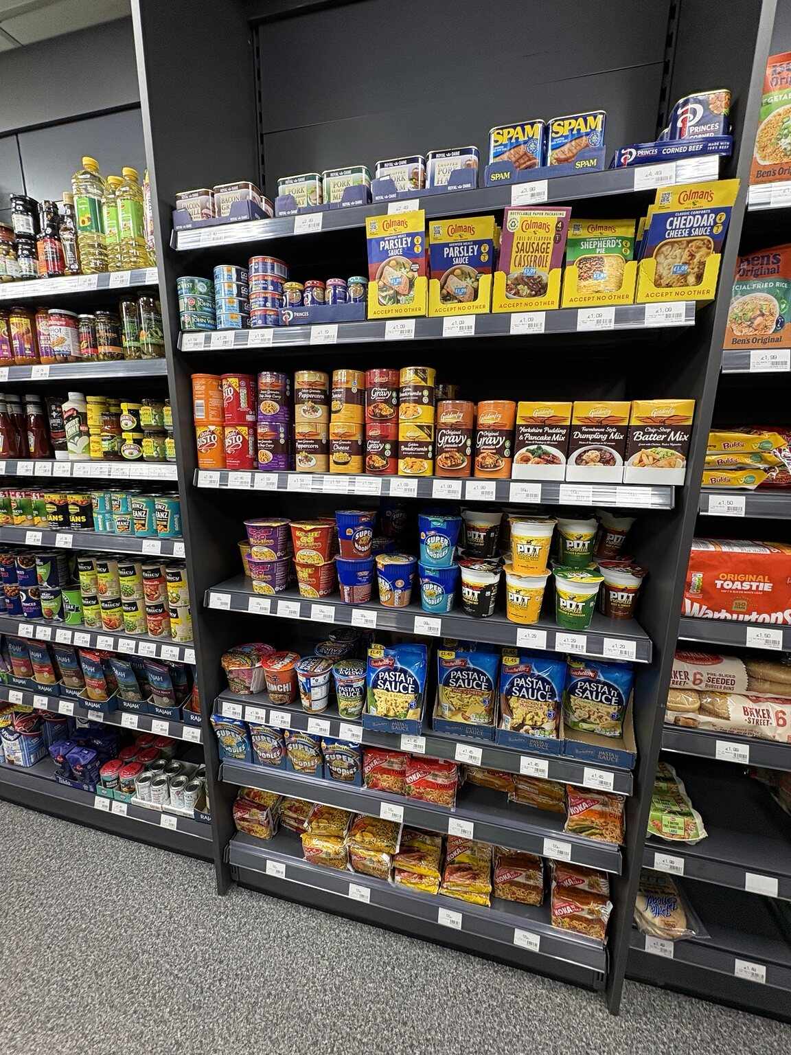 Instant noodles, meal sauces, gravy, tinned meat and quick meals on shelves at C&K Local Store.